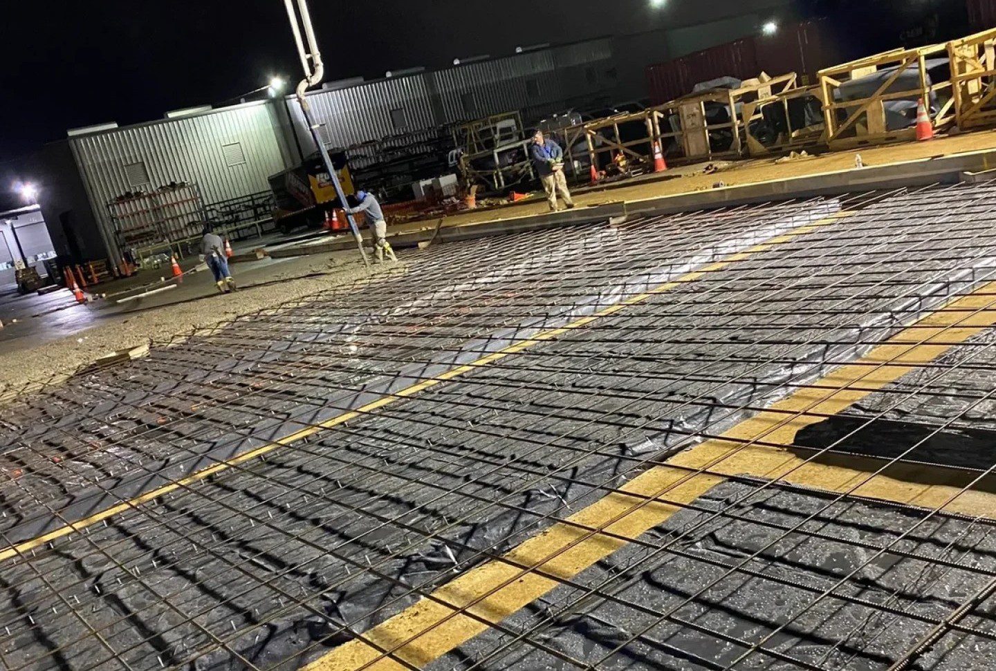Nighttime concrete slab rebar installation in parking lot