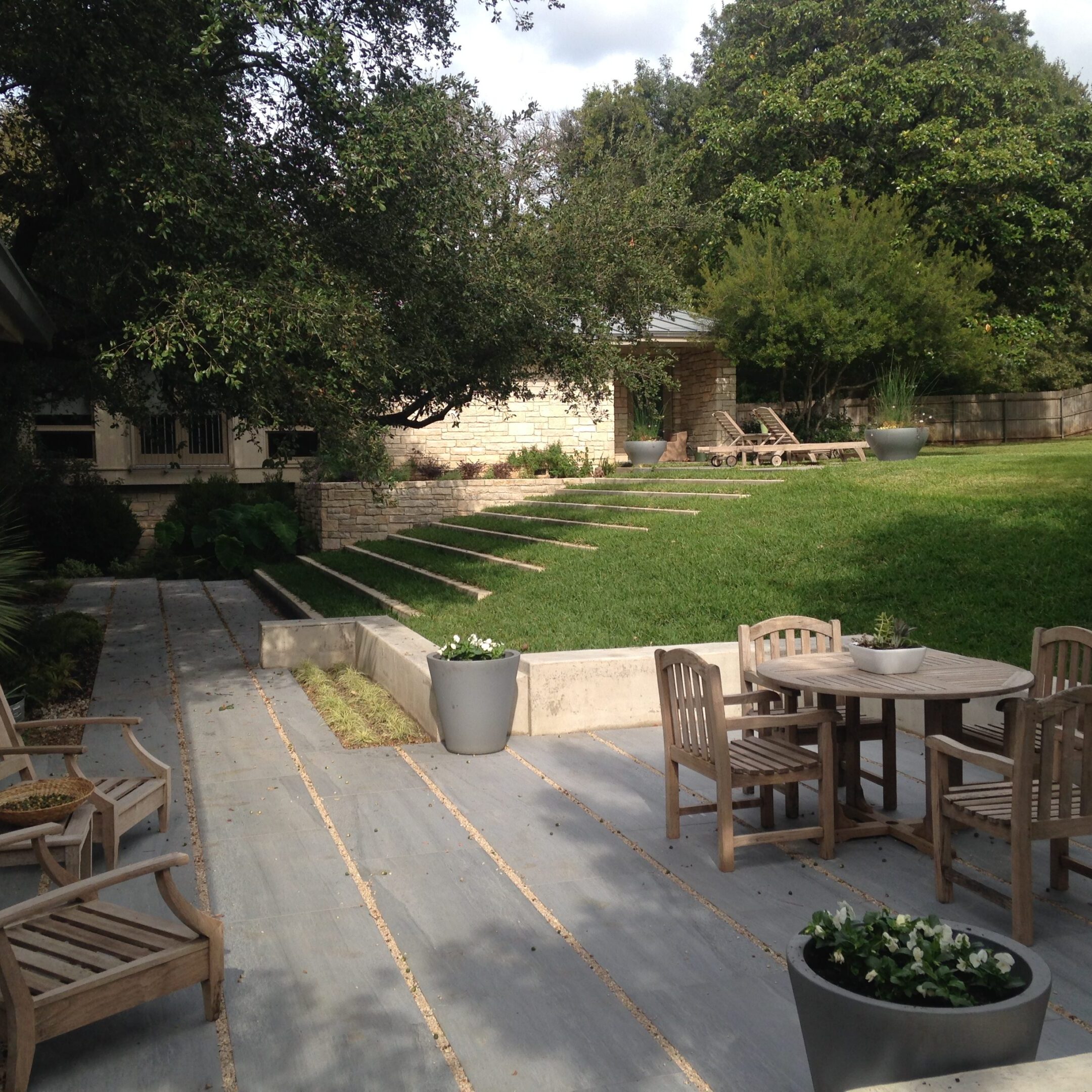 Backyard patio with wooden table and chairs